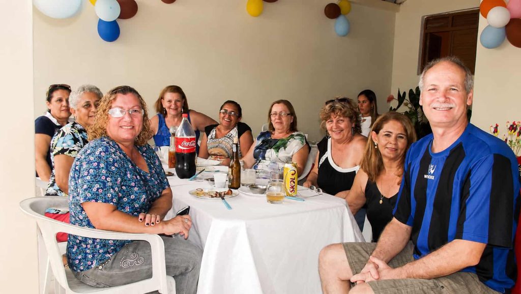 Registro histórico de confraternização entre amigos no bairro Valentina Figueiredo, em João Pessoa. Na imagem aparecem Giselma “Gil”, fundadora da tradicional GIL GAMES, ao lado esquerdo da mesa, e Petrúcio Prado, da Folha do Valentina e TV Jampa, ao lado direito. O encontro aconteceu durante a festa de aniversário de Rejane Leite, reunindo amigos em um momento de alegria, amizade e memória afetiva da comunidade.